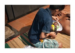 Young Boy Adding the Face Decoration
