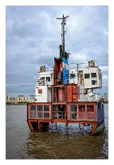 London in October 22  A Slice of Reality is a work of modern art by Richard Wilson sitting by (and commissioned for) the Millennium Dome on the north-western bank of the Greenwich Peninsula. It consists of a sliced vertical section through the former sand dredger Arco Trent and exposes portions of the former living quarters of the vessel to the elements (such as a visible pool table in the lower decks).