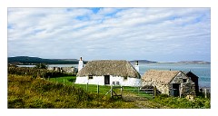 North Uist 08  A Blackhouse with its peat pile of turfs