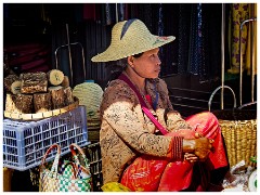 Loikaw  15  Local Market at Demoso West of Loikaw - Behind her a stack of Thanakha Wood for the Face Decoration
