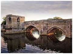 St Ives 18  The Bridge and Chapel -  It was built in the 1420s, replacing the wooden bridge of 300 years earlier.  Notice that the four northern arches have pointed tops – this is how the whole bridge looked originally – but the two southern arches are round-topped. This is because they are later replacements: in 1645, during the Civil War.