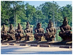 Siem Reap Day One 02  Angkor Thom -a row of  asuras on the right, each row holding a naga in the attitude of a tug-of-war. This appears to be a reference to the myth, popular in Angkor, of the Churning of the Sea of Milk.